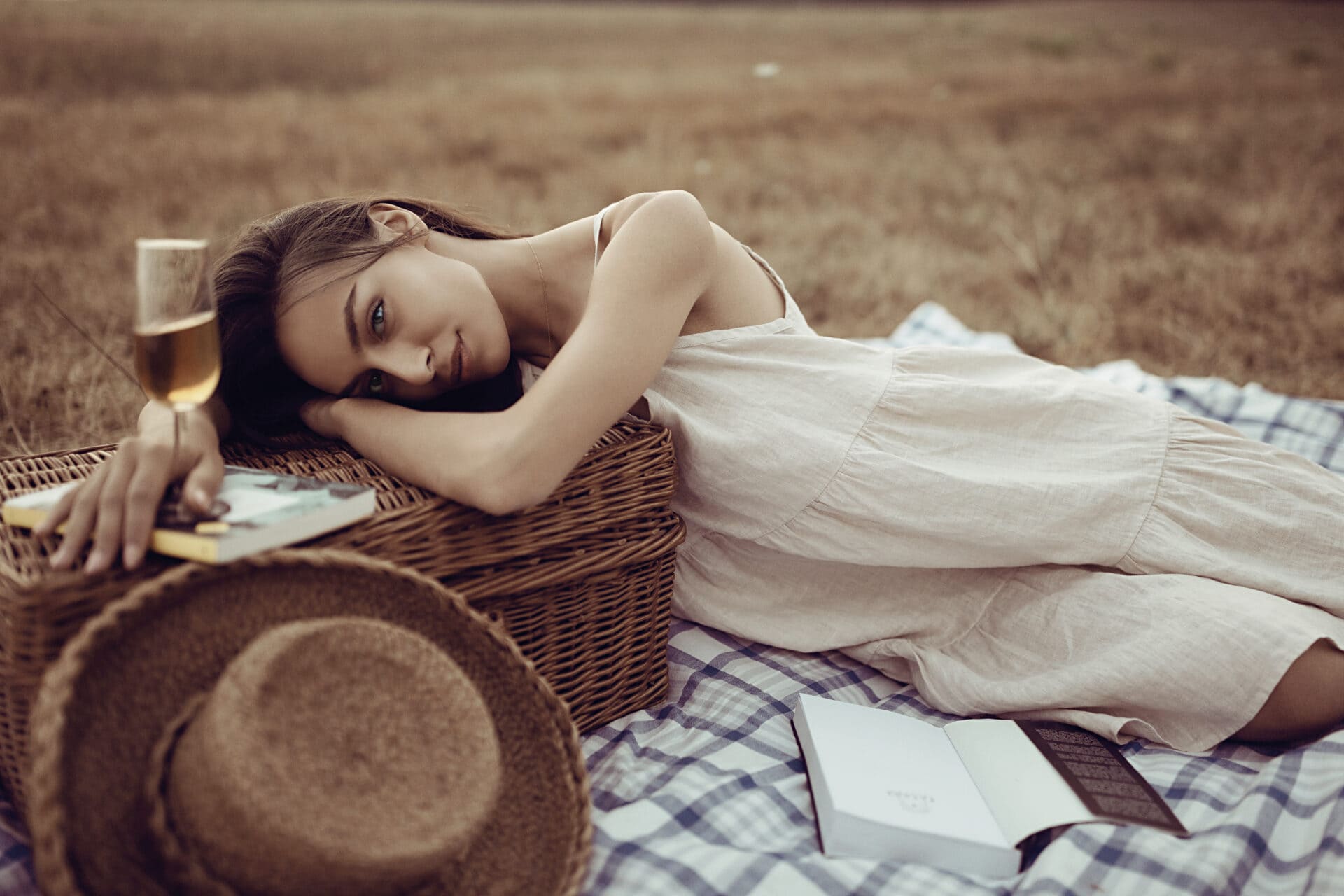 Model wears Terzo Millennio linen dress having a picnic on the lawn